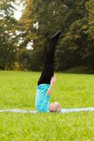 Woman doing yoga in nature photo