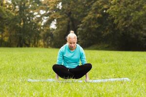 Woman doing yoga in nature photo