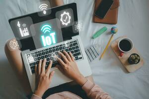 IOT Internet of things, Person hand using laptop computer with VR screen Internet of things icon background, Digital transformation, Modern technology concept. photo