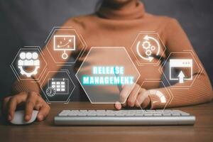 Release management concept, Business woman using computer on desk with release management icon on virtual screen. photo