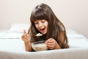 Little girl having healthy breakfast photo