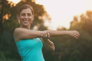 Beautiful woman enjoys exercising in the nature.Toned image. photo