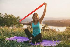 Beautiful sporty woman exercise with rubber band photo