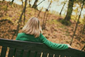 Lonely woman sitting   on a bench in the park. photo