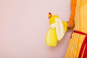 Image of housewife cleaning with spray bottle and mop. photo