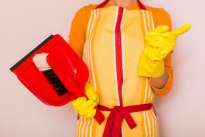 Image of housewife holding dustpan and scolding. photo