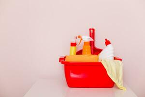 Image of basket with cleaning equipment  on the table. photo