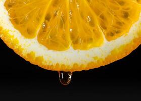 An orange, sliced and dripping with juice, indicates juiciness. Orange juice dripping from orange fruit. studio shot fruit with water drops photo