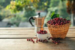 Coffee cherry beans in a basket placed on a wooden table photo