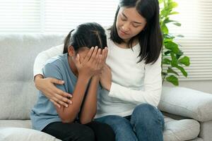 problem in family. mother hug and encourages, feel stressed from the parents quarrel. child is have mental problem. quarrels, violence, depression, suicide, discouragement, social problem photo