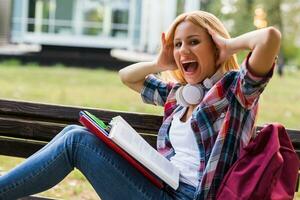 Female student in panic while studying outdoor. photo