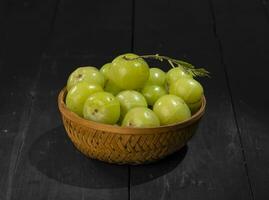 Indian Gooseberry or Amla on Wooden Vintage Background photo