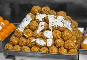 Indian Sweet Food Laddu in Market Stall photo