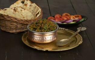 Indian Cuisine Bhindi Masala on Wooden Background photo