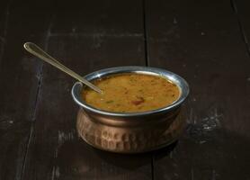 Indian Famous Cuisine Dal Tadka on Vintage Wooden Background photo