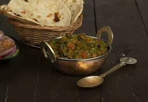 Indian Cuisine Bhindi Masala on Wooden Background photo