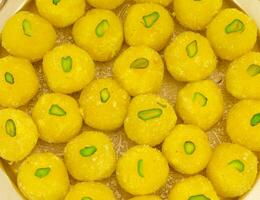 Heap of Indian Traditional Yellow Sweet Food Coconut Laddoo photo