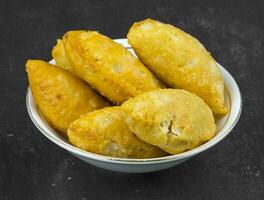 Gujiya or Gujia is a indian sweet dumpling photo