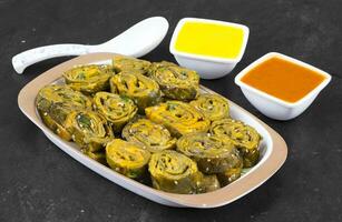 Indian Spicy Food Patra Also Called Paatra, Alu Vadi or Patrode is a Veg Dish in Maharashtra or Gujarati Cuisine. photo