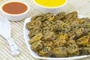 Indian Spicy Food Patra Also Called Paatra, Alu Vadi or Patrode is a Veg Dish in Maharashtra or Gujarati Cuisine. photo