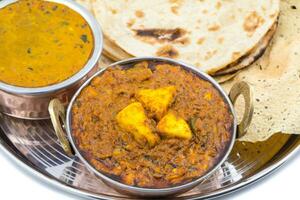 Indian Traditional Thali Food Kadai Paneer Served With Dal Makhani on White Background photo