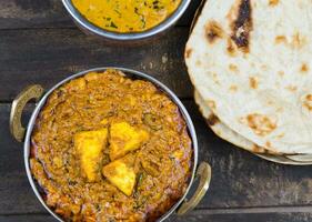 Indian Food Kadai Paneer Served With Dal Makhani, Tandoori or Papad on Wooden Background photo