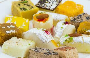 Indian Delicious Mix Sweet Food or Mix Mithai on White Background photo