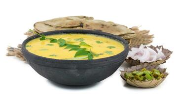 Rajasthani And Gujarati Traditional Cuisine Kadhi or Bajra Roti on White Background photo