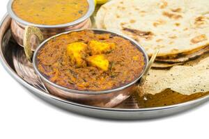 Indian Traditional Thali Food Kadai Paneer Served With Dal Makhani on White Background photo