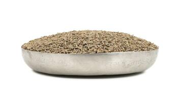 Pile of Dried Cumin Seeds on white Background photo