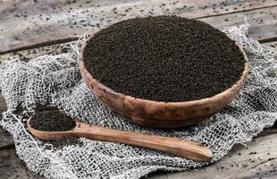 Aromatic Black Tea Loose or Dried Tea Leaves on Wooden Table photo