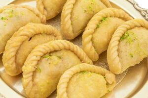 Gujiya or Gujia is a indian sweet food photo