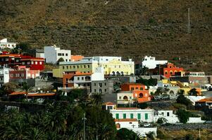 colorful houses on the hillside of a mountain photo