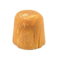 A Block of Indian Jaggery Cane Sugar on white background photo