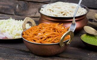 Spicy Fried Vegetable Veg Chow Mein on Wooden Table photo