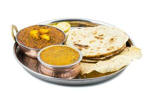 Indian Traditional Thali Food Dal Makhani Served with Chapati, Papad, Kadai Paneer or Lemon on White Background photo