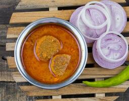 Indian Traditional Cuisine Gatta Curry on Wooden Background photo