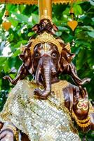 a statue of an elephant with gold and silver decorations photo