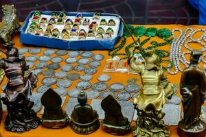 a table with a variety of chinese coins and jewelry photo