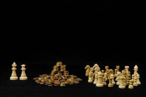 a collection of chess pieces and coins photo