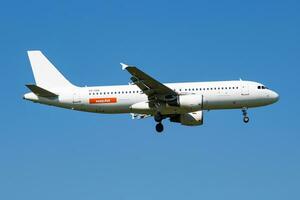 Easyjet Airbus A320 ES-SAQ passenger plane arrival and landing at Vienna Airport photo