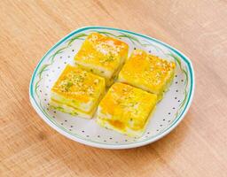 Paneer Burfi or Paneer Kesar Burfi is a Traditional Indian Sweet Food on Wooden Background photo