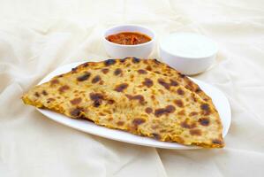 Indian Traditional Breakfast Dish Aloo Paratha Served With Fresh Curd And Pickle photo