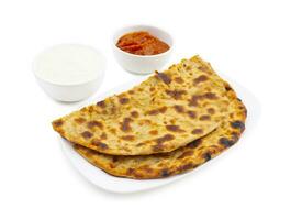 Indian Traditional Breakfast Dish Aloo Paratha Served With Fresh Curd And Pickle photo