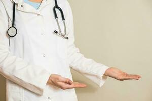 Image of female doctor showing showing welcome gesture. photo