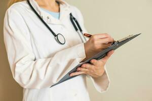 Image of female doctor writing notes. photo