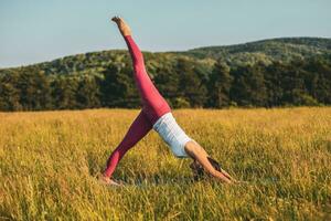 Woman doing yoga in the nature photo