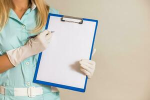 Image of medical nurse showing document. photo