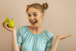Portrait of happy cute woman holding pears and gesturing photo
