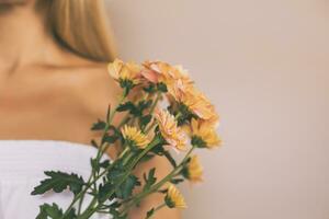 Woman holding beautiful bouquet of flowers.Focus on flowers. photo